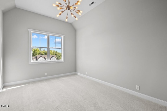 carpeted empty room with vaulted ceiling and a chandelier