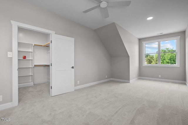 additional living space with light carpet, vaulted ceiling, and ceiling fan