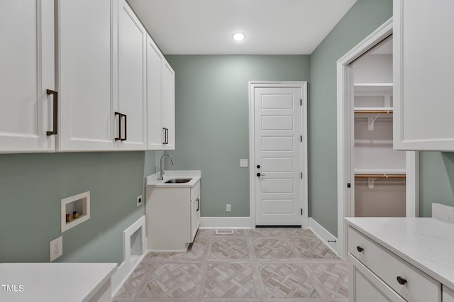 washroom featuring cabinets, washer hookup, hookup for an electric dryer, and sink