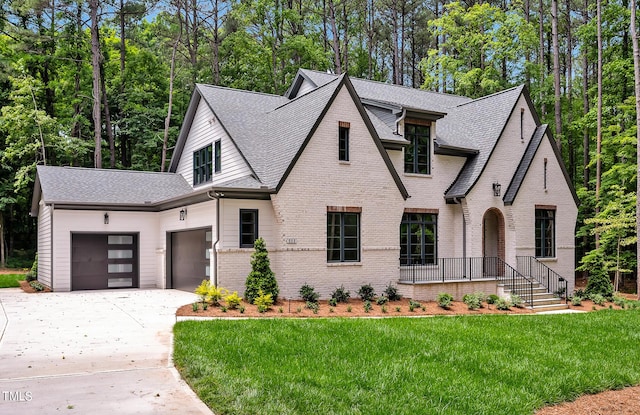 view of front of house with a garage and a front lawn