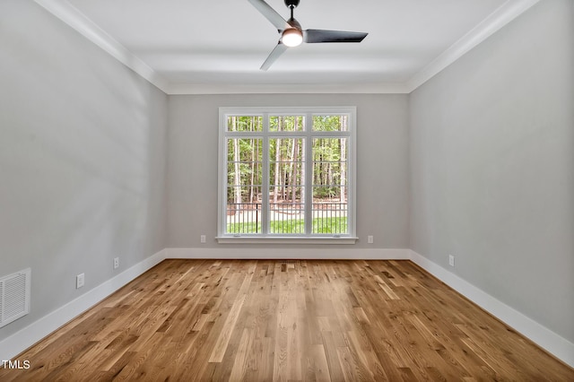 unfurnished room featuring light hardwood / wood-style floors, ceiling fan, and crown molding