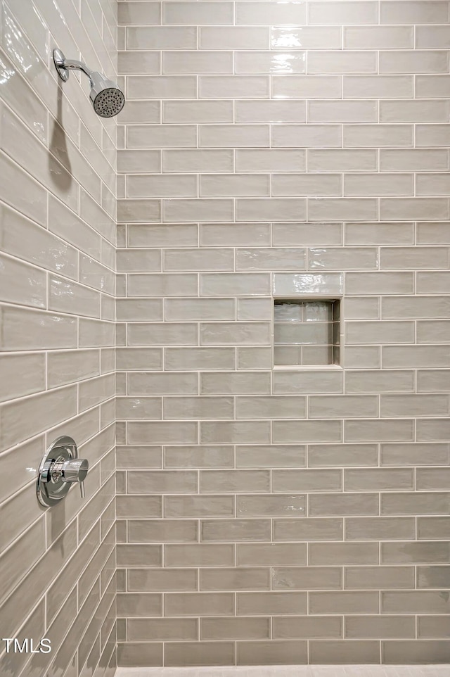 bathroom with a tile shower