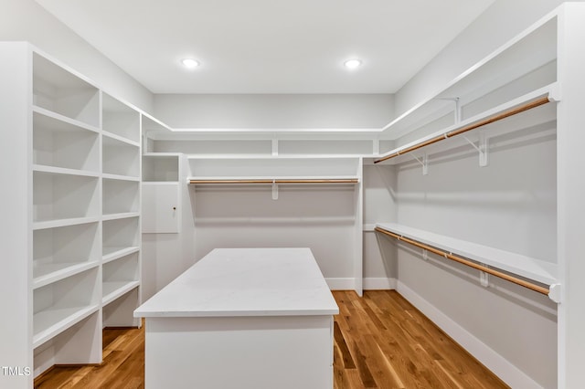 spacious closet featuring light hardwood / wood-style floors