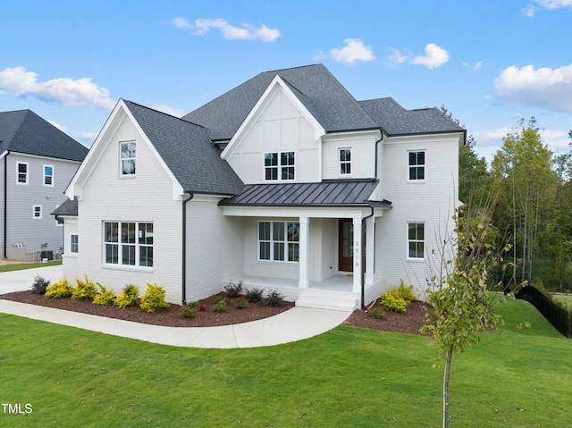 modern farmhouse style home with central AC, a front yard, and a porch