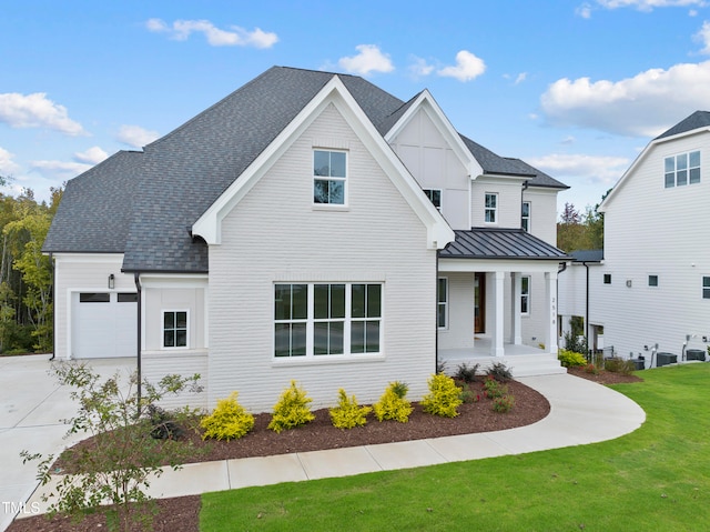 modern farmhouse style home featuring central AC, a porch, a garage, and a front lawn