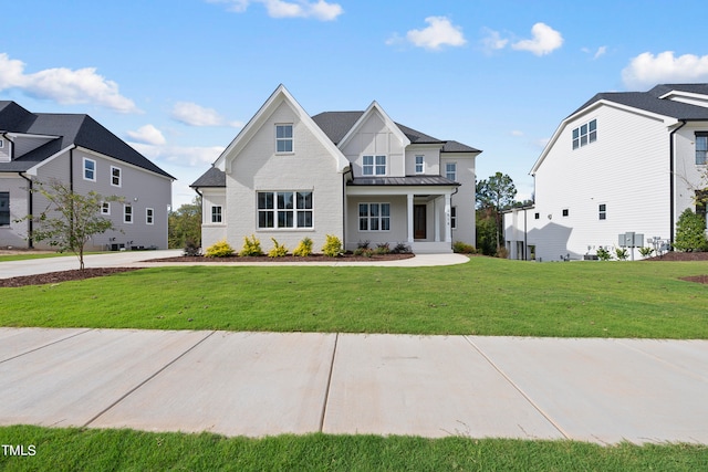 modern farmhouse featuring a front yard