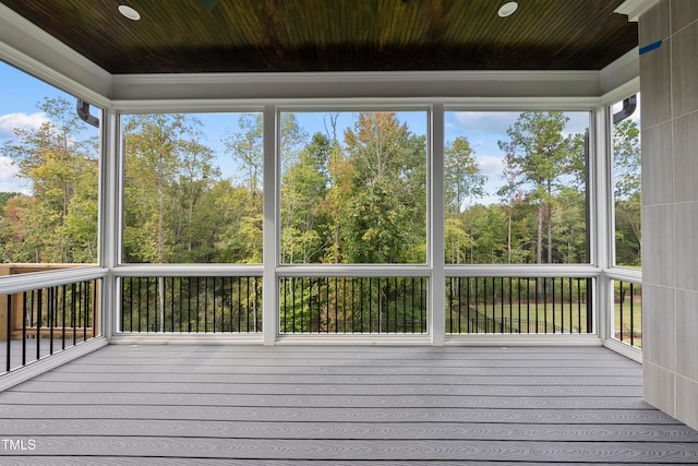 unfurnished sunroom with wooden ceiling