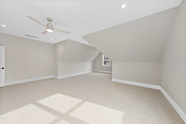 additional living space with vaulted ceiling, light carpet, and ceiling fan