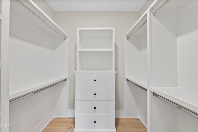 walk in closet featuring light hardwood / wood-style flooring