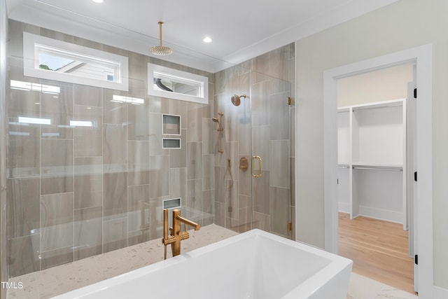 bathroom with sink, ornamental molding, and shower with separate bathtub