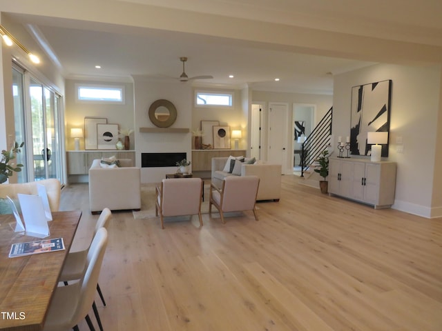 living room with ceiling fan, light wood-type flooring, and a fireplace