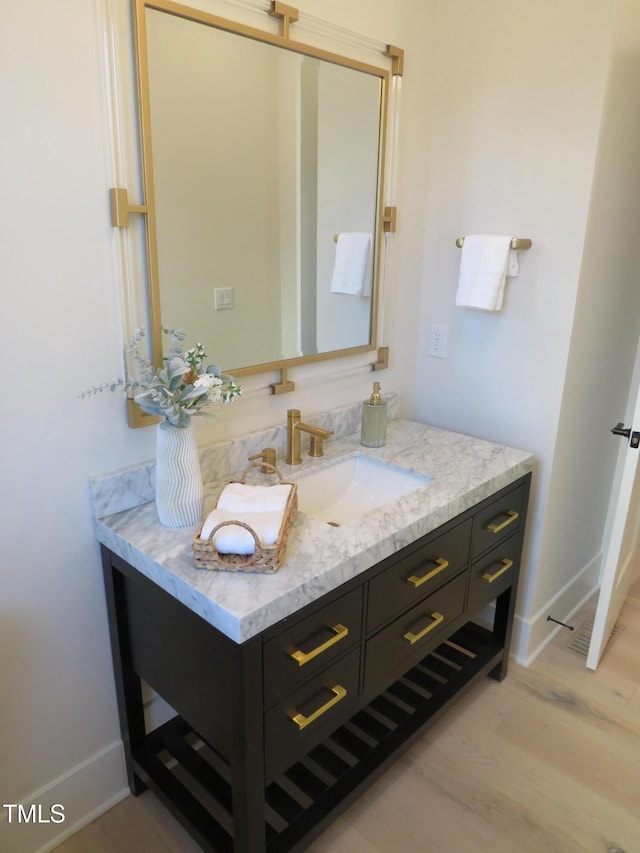 bathroom featuring wood-type flooring and vanity