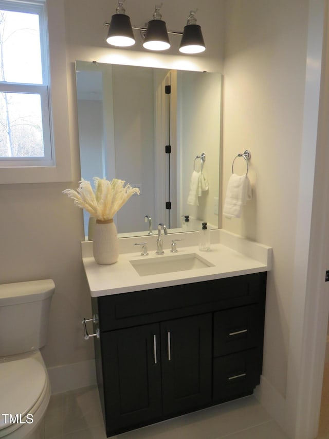 bathroom with tile patterned floors, vanity, and toilet