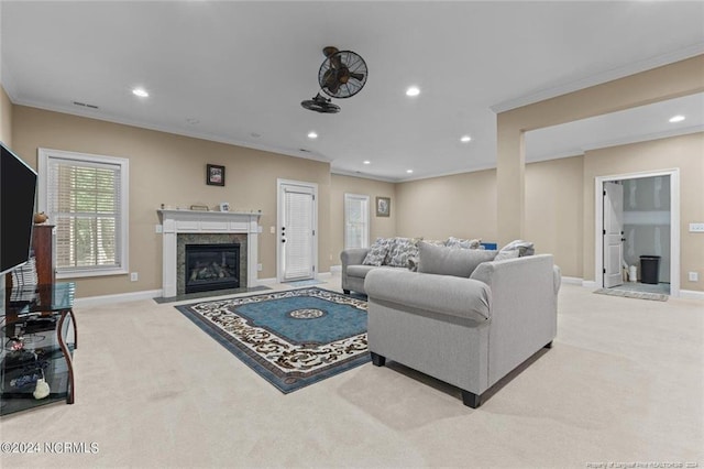 living room featuring light carpet, a fireplace, and crown molding