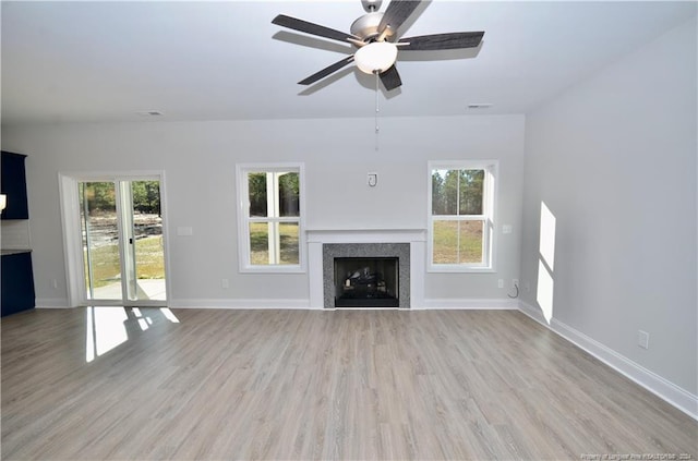 unfurnished living room featuring ceiling fan and light wood-type flooring