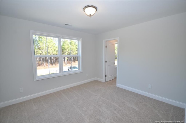 empty room featuring light colored carpet