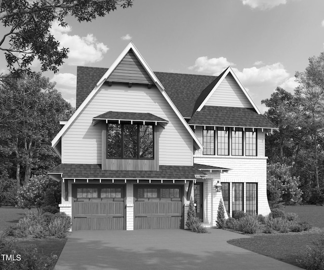 view of front of house with driveway, roof with shingles, and an attached garage