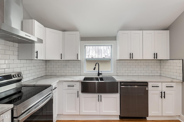 kitchen featuring white cabinetry, electric range, dishwasher, and wall chimney exhaust hood