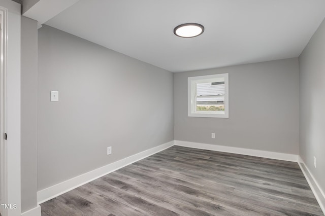 empty room with hardwood / wood-style flooring