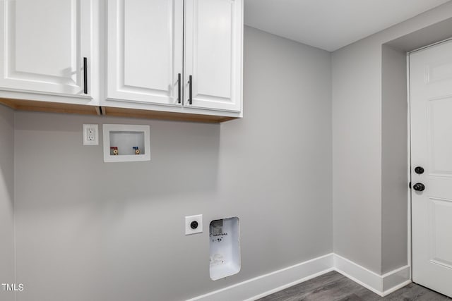 laundry area with cabinets, hookup for a washing machine, dark wood-type flooring, and electric dryer hookup