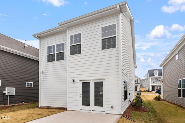 back of property with a patio and a lawn