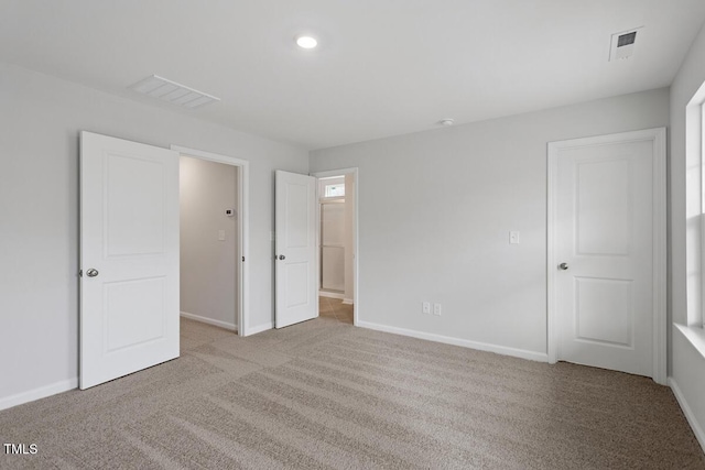 unfurnished bedroom with light colored carpet