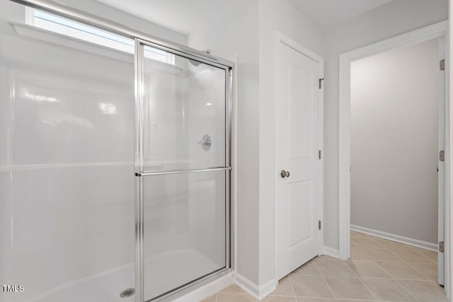 bathroom featuring walk in shower and tile patterned flooring