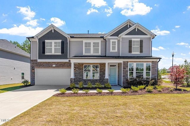 view of front of home with a garage, a porch, and a front lawn