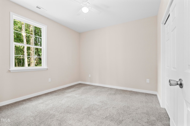 empty room with ceiling fan and carpet floors