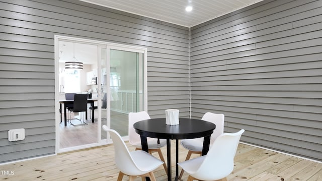 interior space featuring light wood-type flooring and wood walls