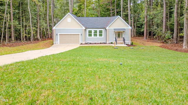 view of front of property with a front yard and a garage