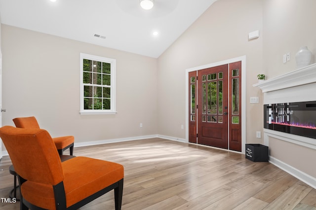 sitting room featuring light hardwood / wood-style flooring, ceiling fan, and high vaulted ceiling