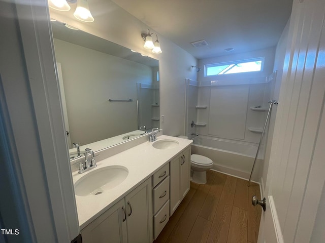 full bathroom with toilet, bathtub / shower combination, vanity, and hardwood / wood-style floors