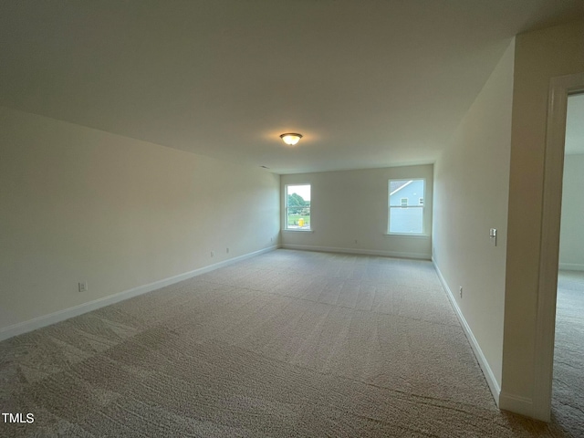 unfurnished room featuring light colored carpet