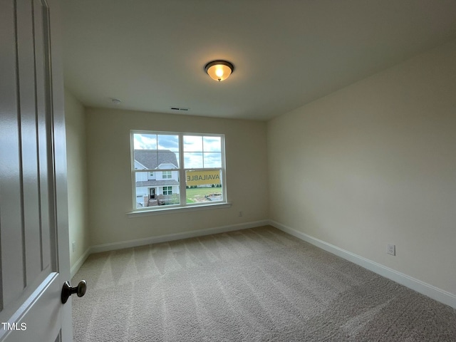 unfurnished room featuring carpet