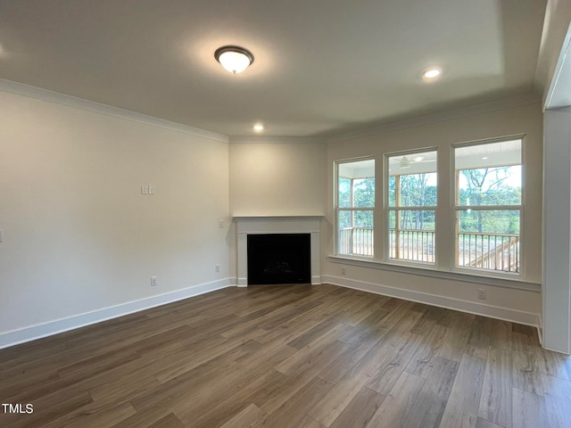 unfurnished living room featuring hardwood / wood-style floors and ornamental molding