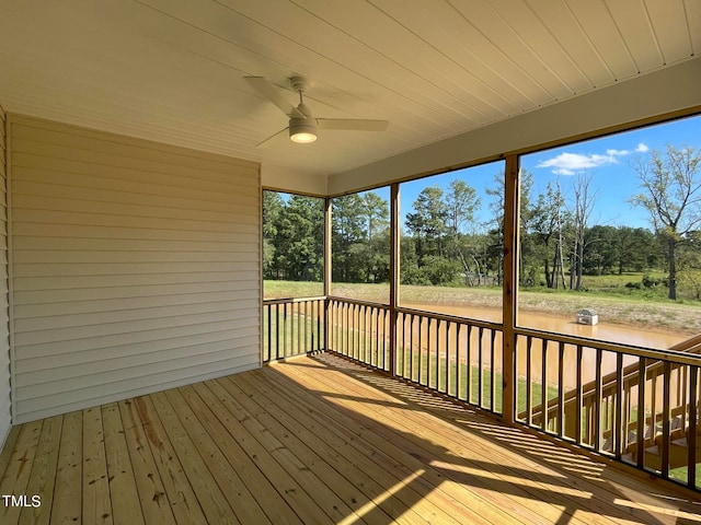 unfurnished sunroom featuring ceiling fan