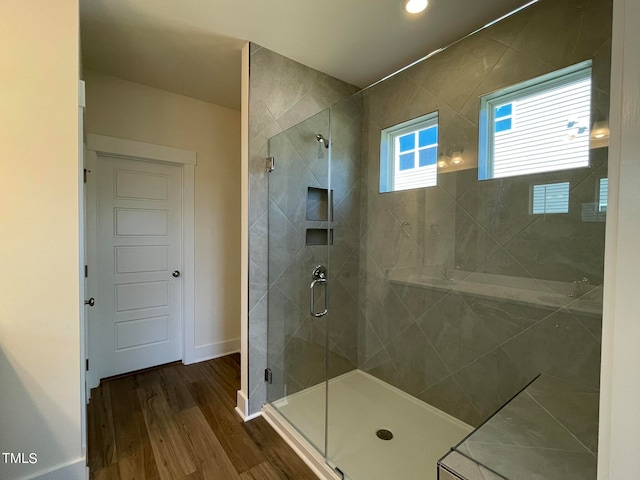 bathroom featuring hardwood / wood-style flooring and a shower with shower door