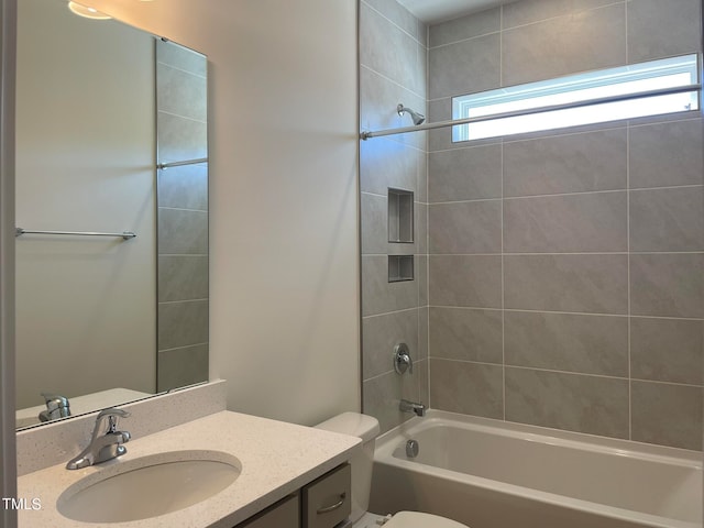 full bathroom with vanity, toilet, and tiled shower / bath