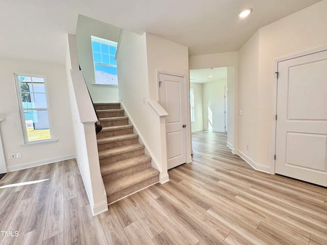 stairs featuring wood-type flooring