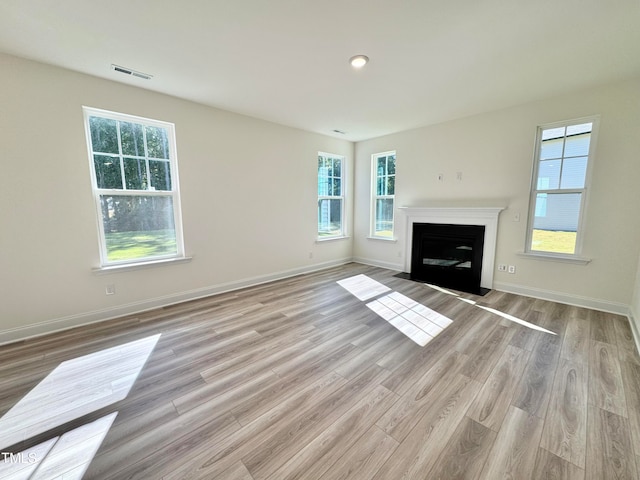 unfurnished living room with light hardwood / wood-style floors