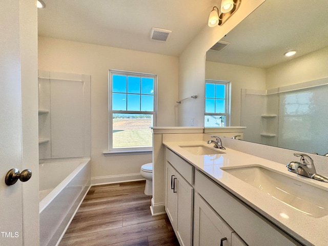 full bathroom featuring bathtub / shower combination, hardwood / wood-style floors, vanity, and toilet