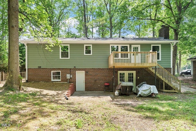 104 Argyle Ct, Garner, NC 27529 - rear view of house featuring a chimney, a wooden deck, and stairs
