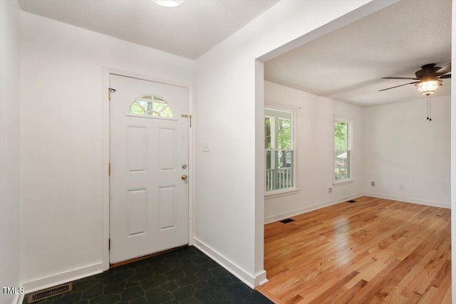 104 Argyle Ct, Garner, NC 27529 - entrance foyer featuring baseboards, visible vents, ceiling fan, and a healthy amount of sunlight
