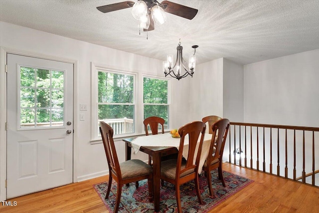 104 Argyle Ct, Garner, NC 27529 - dining area with a textured ceiling, light wood finished floors, and ceiling fan with notable chandelier