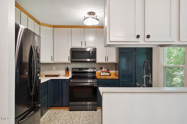 104 Argyle Ct, Garner, NC 27529 - kitchen with white cabinets, light countertops, a sink, tasteful backsplash, and appliances with stainless steel finishes