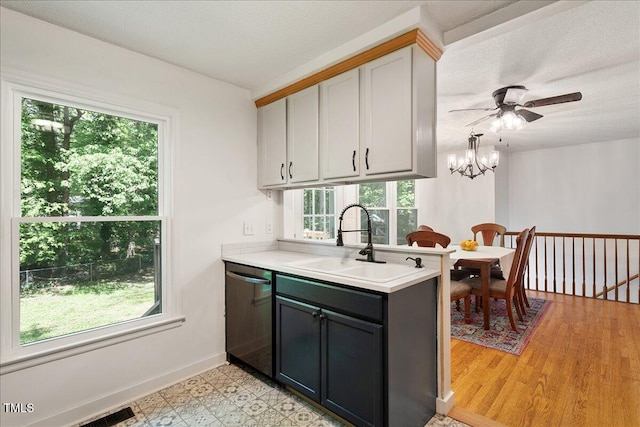 104 Argyle Ct, Garner, NC 27529 - kitchen featuring plenty of natural light, stainless steel dishwasher, light countertops, and a sink