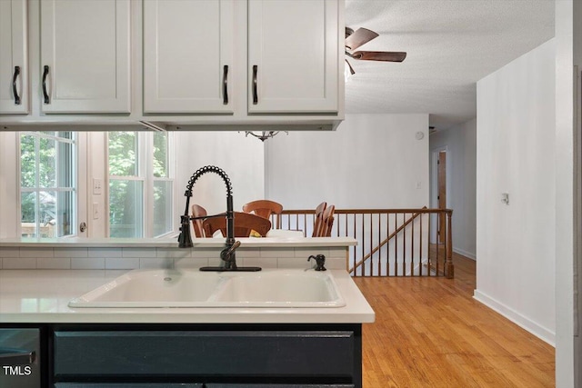 104 Argyle Ct, Garner, NC 27529 - kitchen featuring a ceiling fan, a sink, light wood-type flooring, light countertops, and baseboards