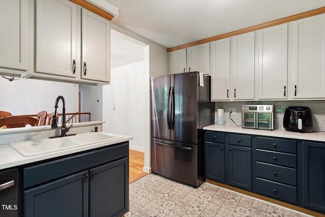 104 Argyle Ct, Garner, NC 27529 - kitchen featuring tasteful backsplash, a sink, light floors, light countertops, and freestanding refrigerator