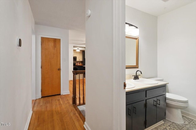 104 Argyle Ct, Garner, NC 27529 - bathroom featuring toilet, vanity, wood finished floors, and baseboards
